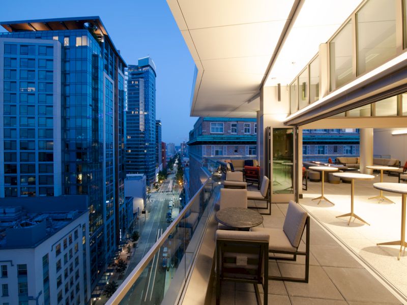 A balcony with a city view at evening